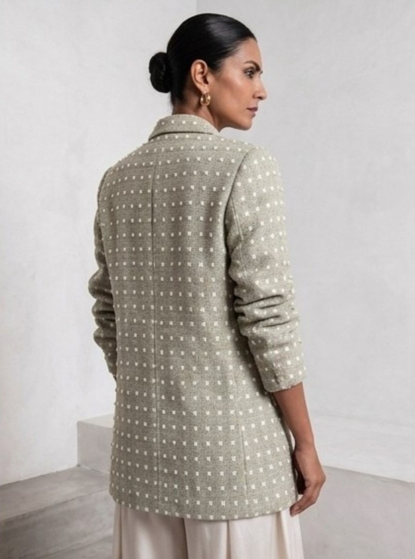 Back view of light sage green Ping Me blazer styled with ivory trousers.