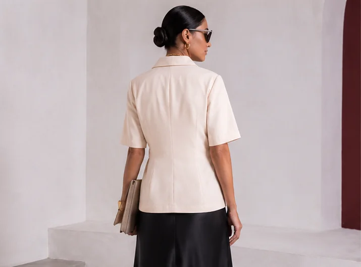 Back view of cream Final Draft short-sleeve blazer showing the clean tailored back.